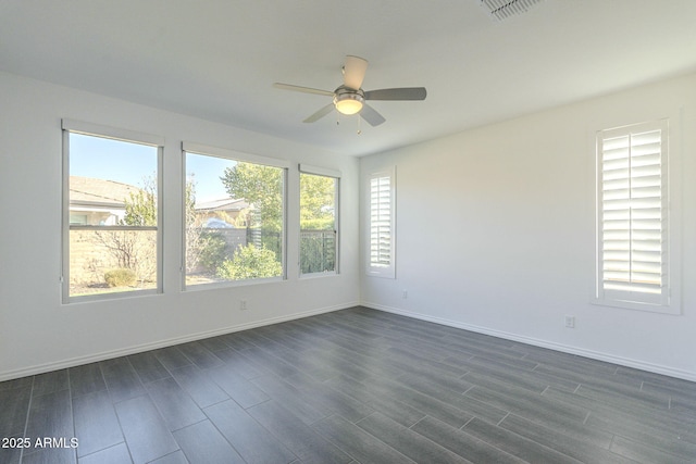 unfurnished room featuring ceiling fan and dark hardwood / wood-style flooring