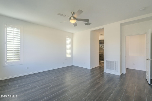 spare room featuring ceiling fan and dark wood-type flooring