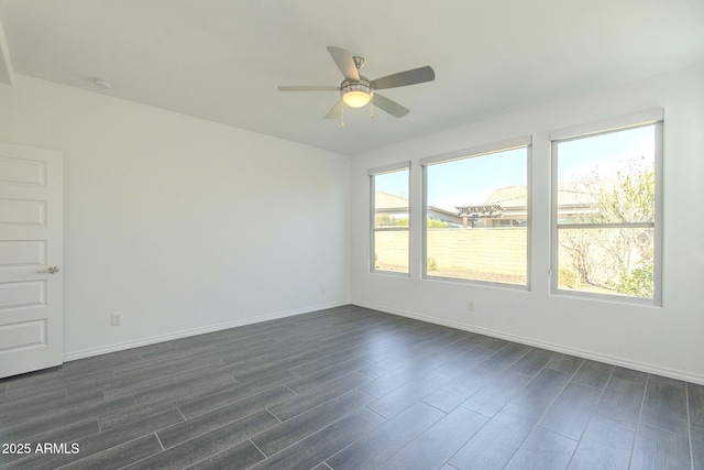 spare room featuring dark hardwood / wood-style floors and ceiling fan