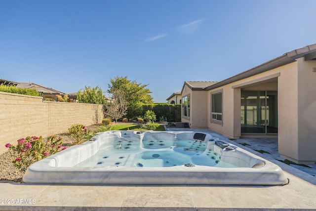 view of pool with a hot tub