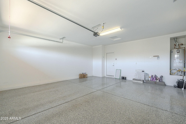 garage featuring a garage door opener and gas water heater