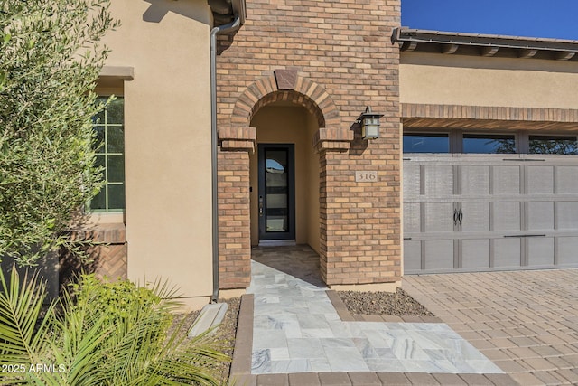 doorway to property with a garage