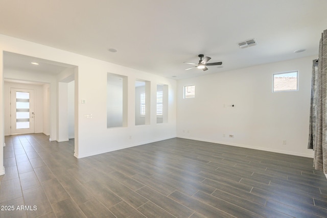 empty room with ceiling fan and a wealth of natural light