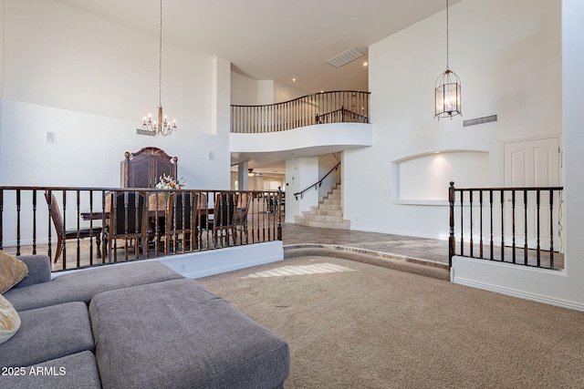12925 W Llano Dr, Litchfield Park, AZ 85340 - living room featuring a chandelier, visible vents, baseboards, stairs, and carpet