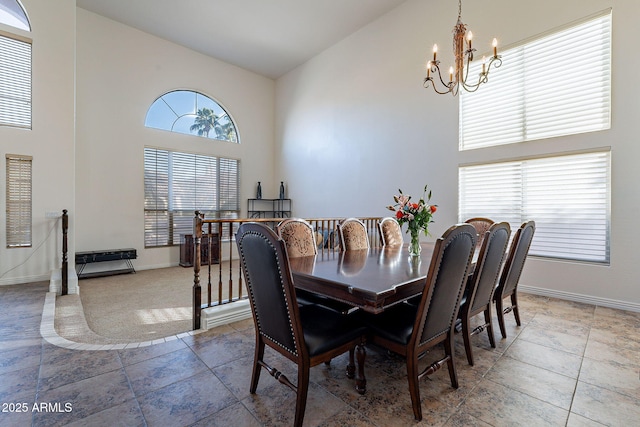 12925 W Llano Dr, Litchfield Park, AZ 85340 - dining room featuring an inviting chandelier, baseboards, and high vaulted ceiling