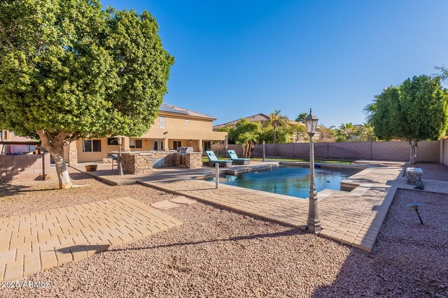 12925 W Llano Dr, Litchfield Park, AZ 85340 - view of swimming pool featuring a patio area, an outdoor bar, a fenced backyard, and a fenced in pool