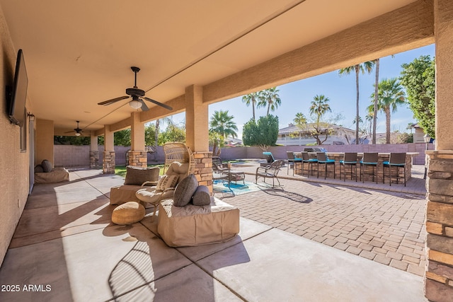 12925 W Llano Dr, Litchfield Park, AZ 85340 - view of patio with a ceiling fan, outdoor dining area, a fenced backyard, and a bar