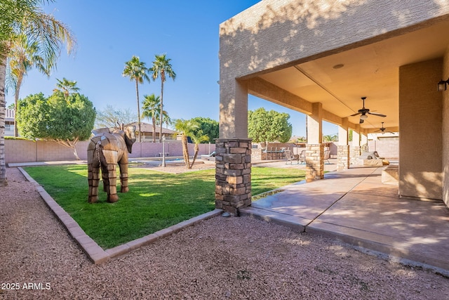 12925 W Llano Dr, Litchfield Park, AZ 85340 - view of yard featuring ceiling fan, a fenced backyard, and a patio