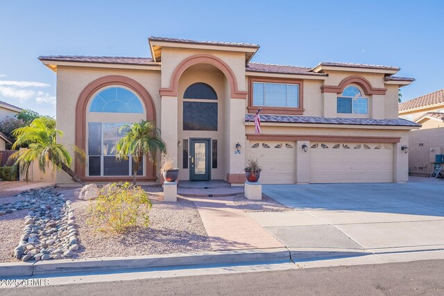 12925 W Llano Dr, Litchfield Park, AZ 85340 - mediterranean / spanish home with a garage, driveway, and stucco siding