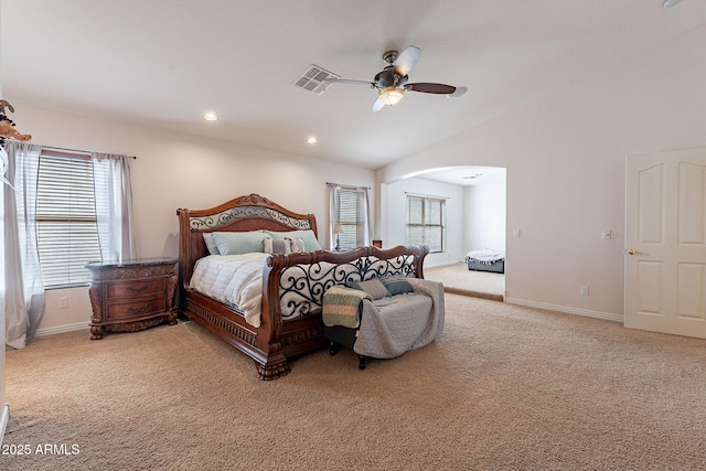 12925 W Llano Dr, Litchfield Park, AZ 85340 - carpeted bedroom with arched walkways, visible vents, vaulted ceiling, and baseboards
