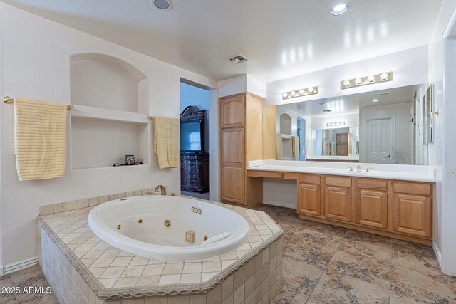 12925 W Llano Dr, Litchfield Park, AZ 85340 - full bathroom with a tub with jets, visible vents, and vanity