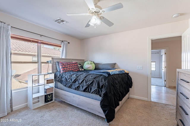 12925 W Llano Dr, Litchfield Park, AZ 85340 - bedroom featuring light carpet, baseboards, visible vents, and a ceiling fan