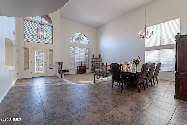 12925 W Llano Dr, Litchfield Park, AZ 85340 - dining space with high vaulted ceiling, a notable chandelier, and baseboards