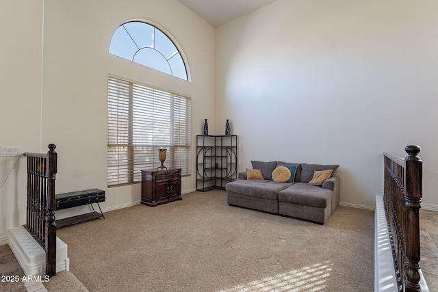 12925 W Llano Dr, Litchfield Park, AZ 85340 - living area with carpet flooring, a towering ceiling, and baseboards