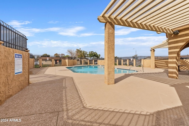 view of pool with a patio and a pergola