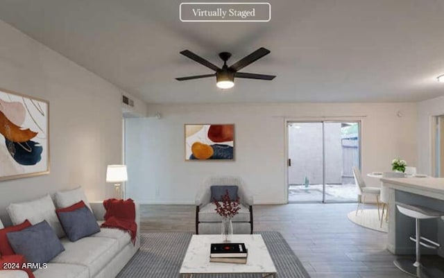 living room with ceiling fan and wood-type flooring