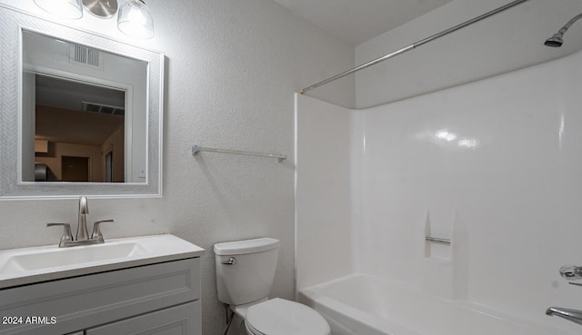 full bathroom with  shower combination, vanity, and toilet