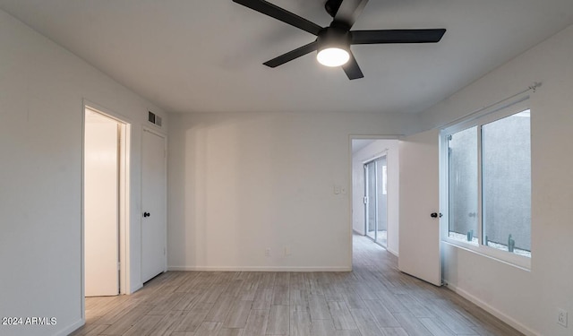 unfurnished room with light hardwood / wood-style flooring and ceiling fan