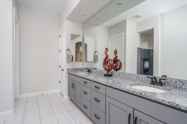 bathroom featuring tile patterned floors and double vanity