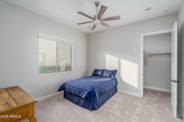 bedroom with light carpet and ceiling fan