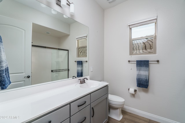 bathroom featuring hardwood / wood-style flooring, toilet, and vanity