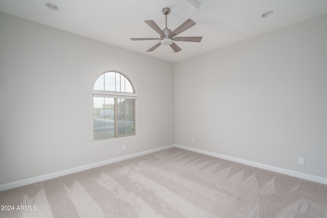 carpeted empty room featuring ceiling fan