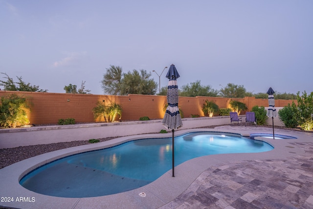 view of pool featuring an in ground hot tub and a patio area