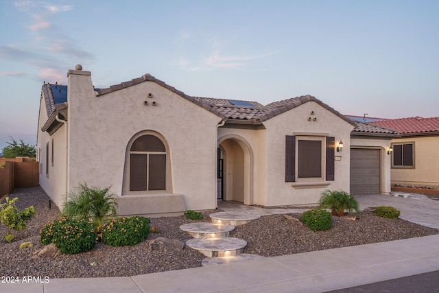 mediterranean / spanish-style home featuring a garage