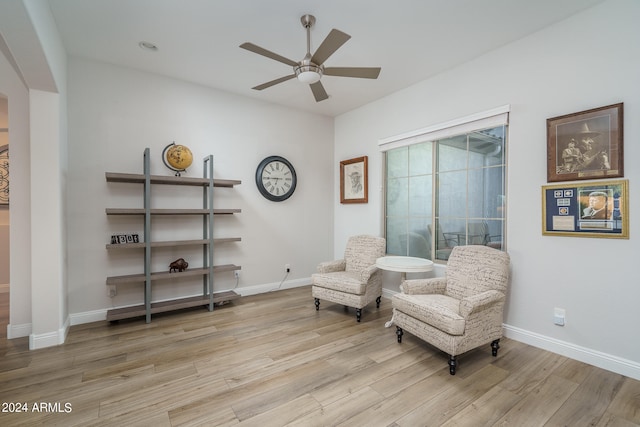 sitting room featuring ceiling fan and hardwood / wood-style floors