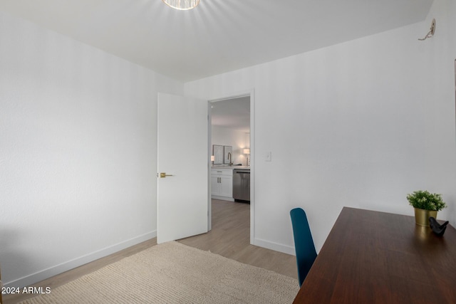 unfurnished office featuring light wood-type flooring and sink