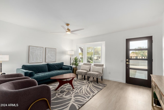 living room featuring plenty of natural light, light hardwood / wood-style floors, and ceiling fan