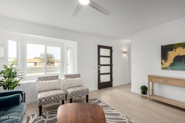 living room with light wood-type flooring and ceiling fan