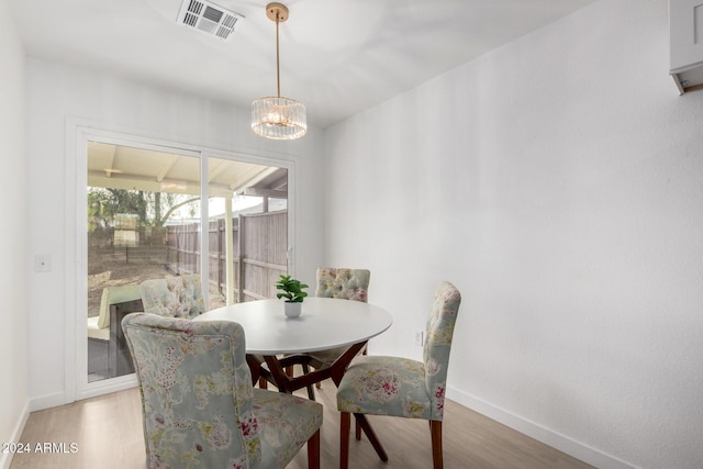 dining room featuring hardwood / wood-style floors and a notable chandelier