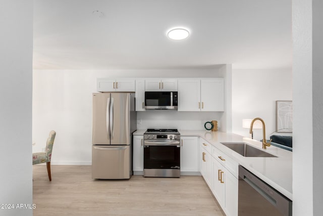 kitchen featuring white cabinets, sink, and appliances with stainless steel finishes