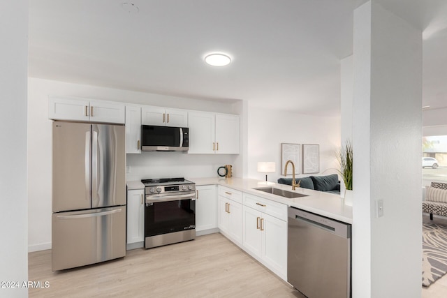 kitchen featuring white cabinetry, sink, and appliances with stainless steel finishes