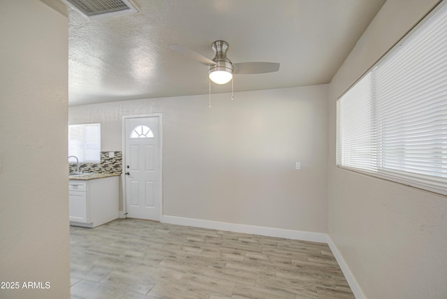3408 W Virginia Ave, Phoenix, AZ 85009 - unfurnished room with ceiling fan, baseboards, and light wood-style floors