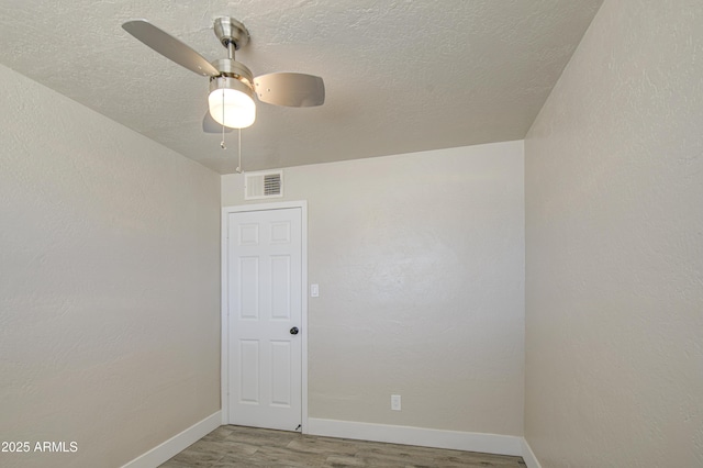 3408 W Virginia Ave, Phoenix, AZ 85009 - spare room featuring wood finished floors, a ceiling fan, baseboards, and a textured ceiling