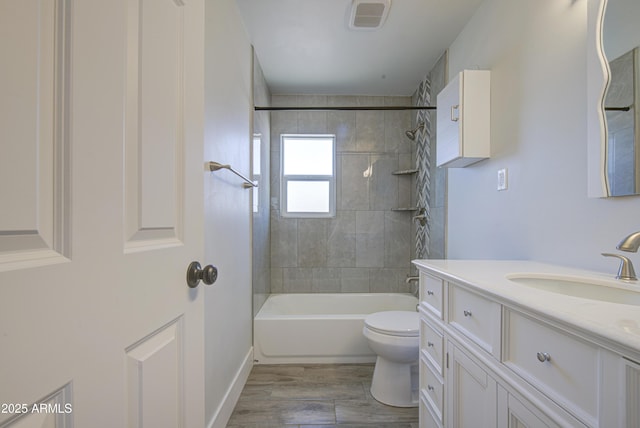3408 W Virginia Ave, Phoenix, AZ 85009 - full bathroom with vanity, toilet, bathing tub / shower combination, and wood finished floors