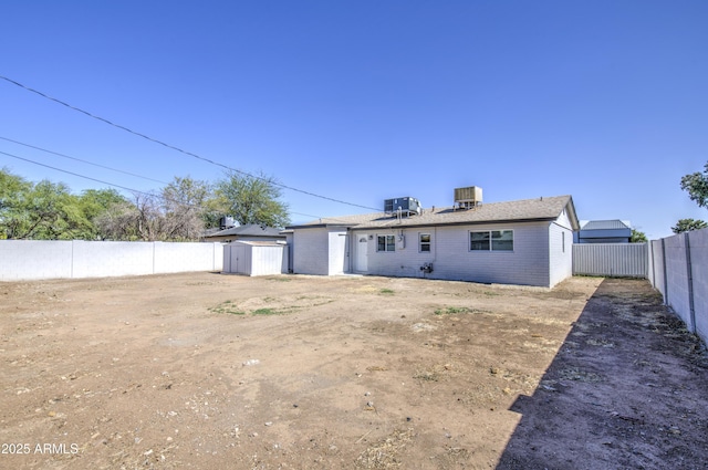 3408 W Virginia Ave, Phoenix, AZ 85009 - rear view of property featuring central AC unit, brick siding, and a fenced backyard