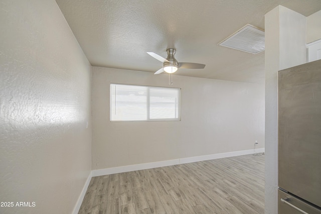 3408 W Virginia Ave, Phoenix, AZ 85009 - unfurnished room featuring wood finished floors, a ceiling fan, baseboards, and a textured ceiling