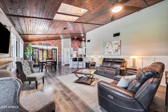 13207 N 55th Ave, Glendale, AZ 85304 - living room featuring wooden ceiling, a ceiling fan, a skylight, wood finished floors, and wainscoting