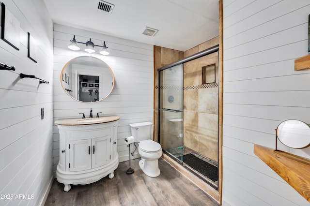 13207 N 55th Ave, Glendale, AZ 85304 - full bath featuring a stall shower, vanity, wooden walls, and wood finished floors