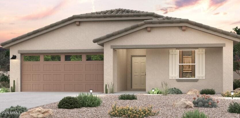 1690 W Posada St, Coolidge, AZ 85128 - view of front of house featuring a garage, stucco siding, and driveway