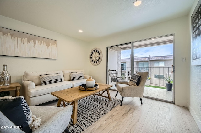 living area featuring recessed lighting, light wood-style flooring, and baseboards