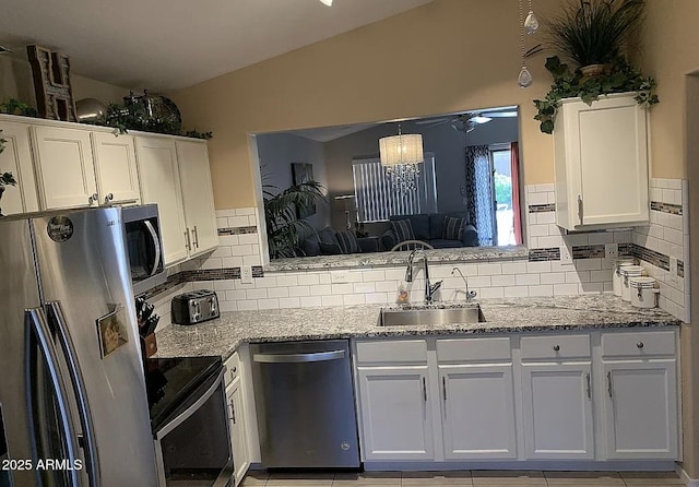 30178 N Coral Bean Dr, San Tan Valley, AZ 85143 - kitchen featuring stainless steel appliances, a sink, white cabinetry, and tasteful backsplash