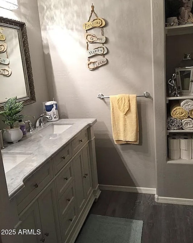 30178 N Coral Bean Dr, San Tan Valley, AZ 85143 - bathroom with wood finished floors, double vanity, and baseboards