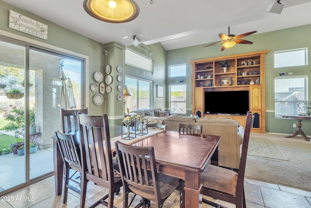 dining space featuring light carpet, light tile patterned floors, and a ceiling fan