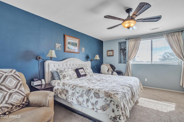 bedroom with carpet floors, ceiling fan, visible vents, and baseboards