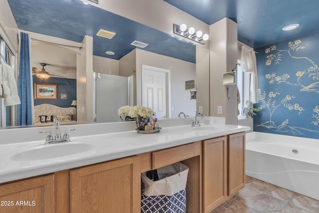 full bathroom with a bath, double vanity, visible vents, and a sink