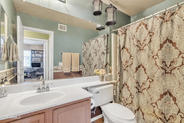 bathroom featuring visible vents, vanity, and toilet